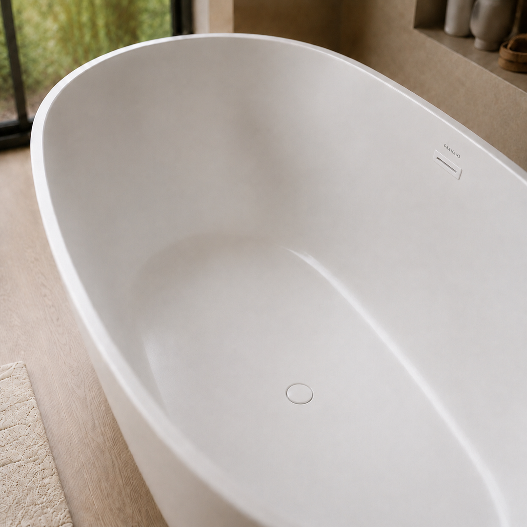 Laren 59 inch freestanding bathtub, close-up of matching white drain, Gramans Bathware