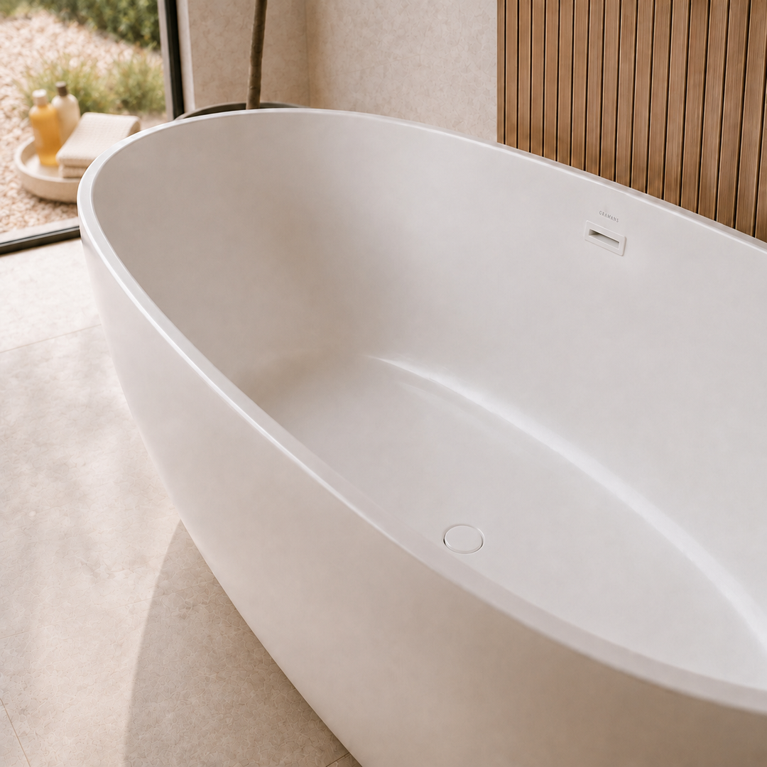 Laren 67 inch freestanding bathtub, close-up of matching white drain, Gramans Bathware